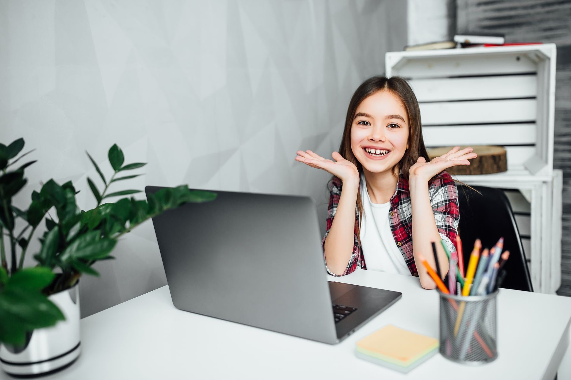 Girl smiling in front of laptop computer